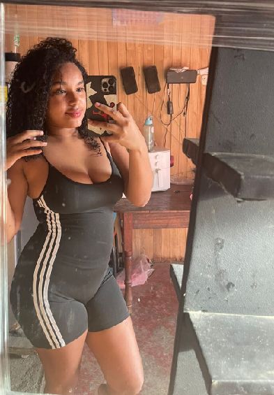 Confident adult woman looking at the camera in a private video chat